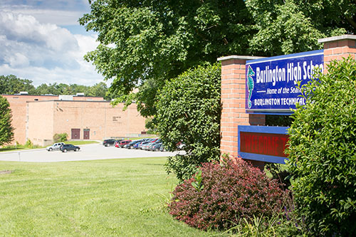 The exterior of BHS with grass and a large sign in front of the building.