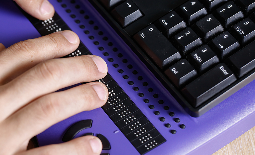 A close up of a braille keyboard.