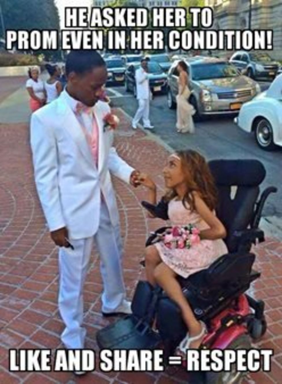 A young man in a white tux stands with a young woman in a prom dress in a wheelchair. There are other going to prom behind them. The photo says "He asked her to prom even in her condition! Like and share = Respect"